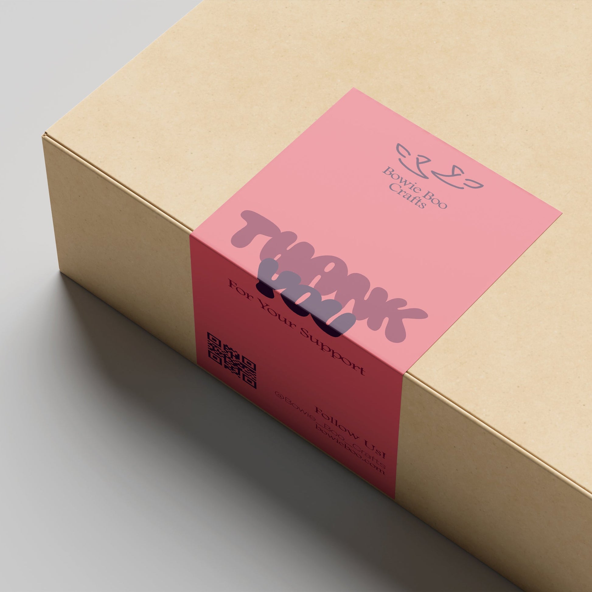 Cardboard box with a pink label on a gray background
