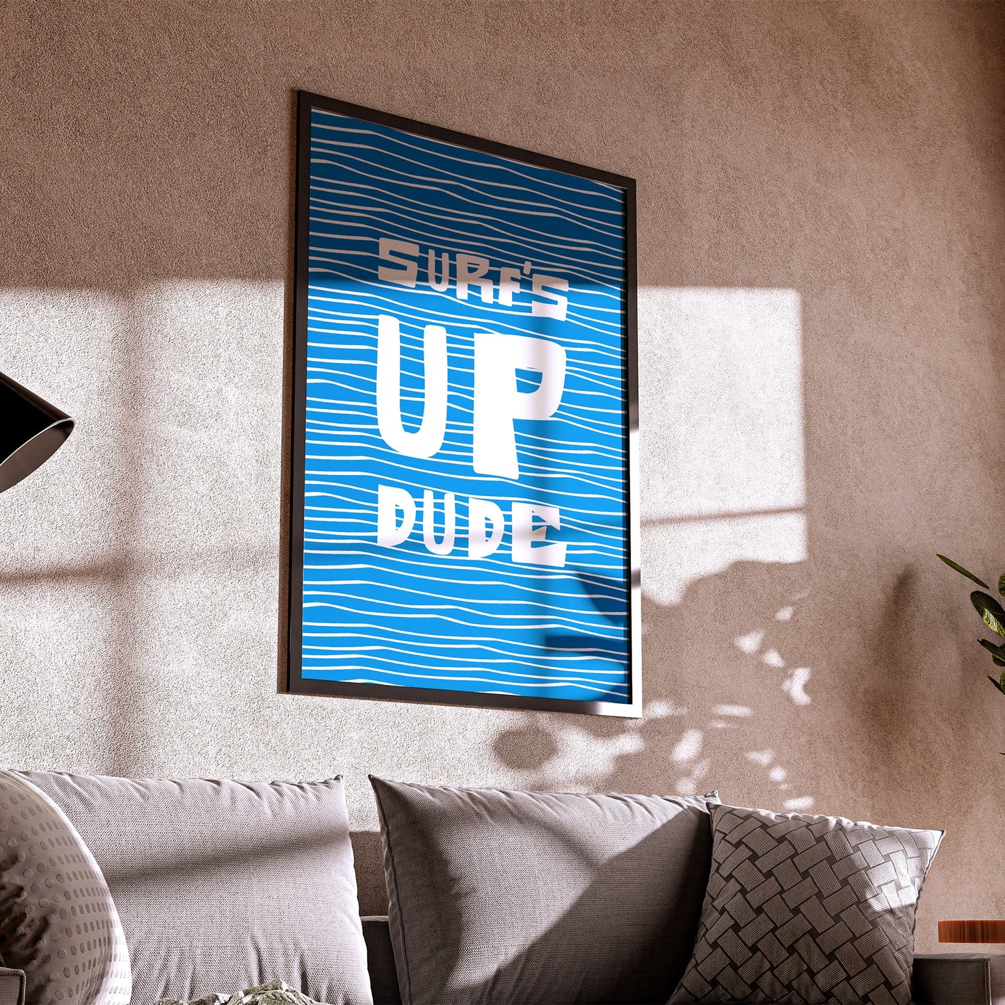 Living room with a framed poster on the wall and a couch in the foreground.