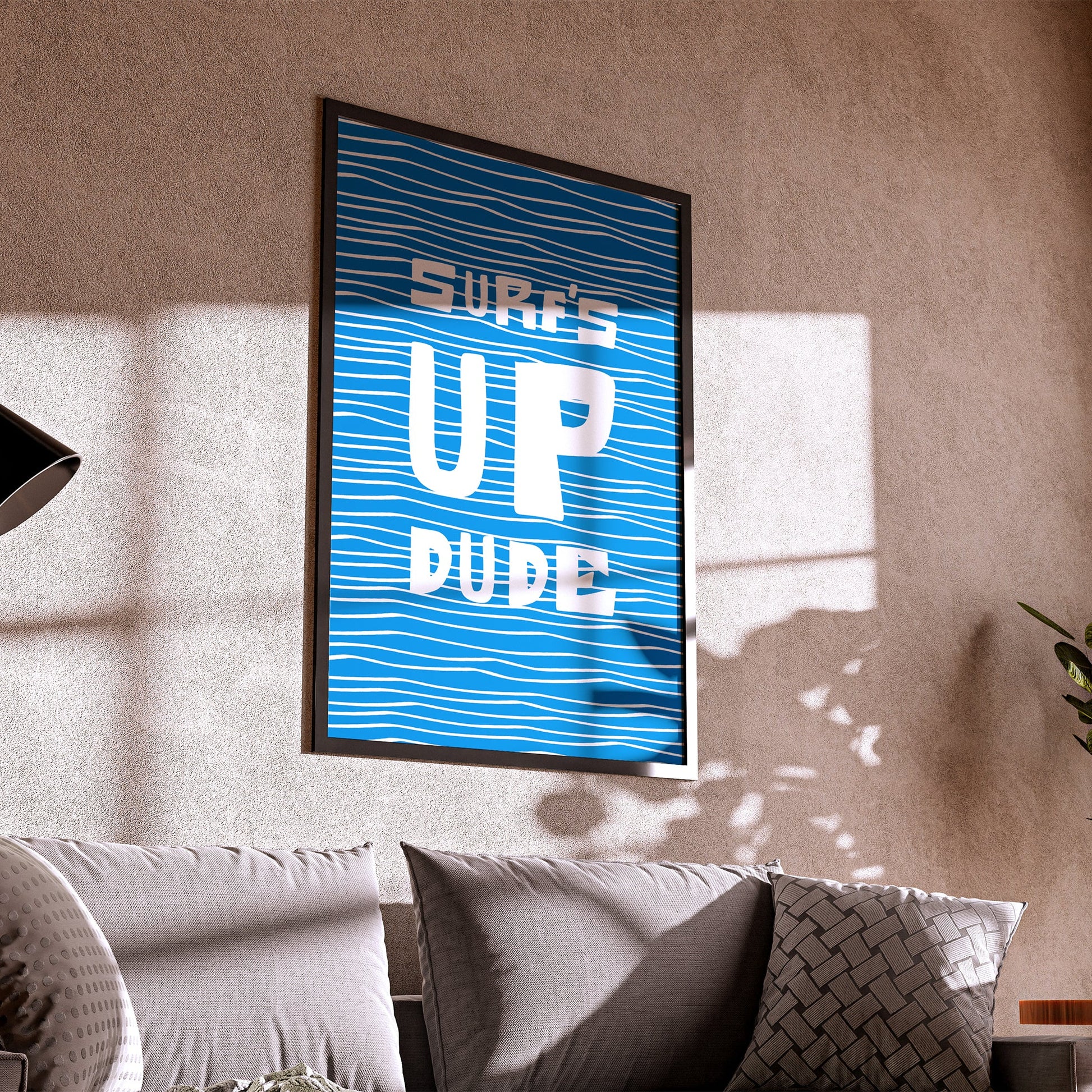 Living room with a framed poster on the wall and a couch in the foreground.