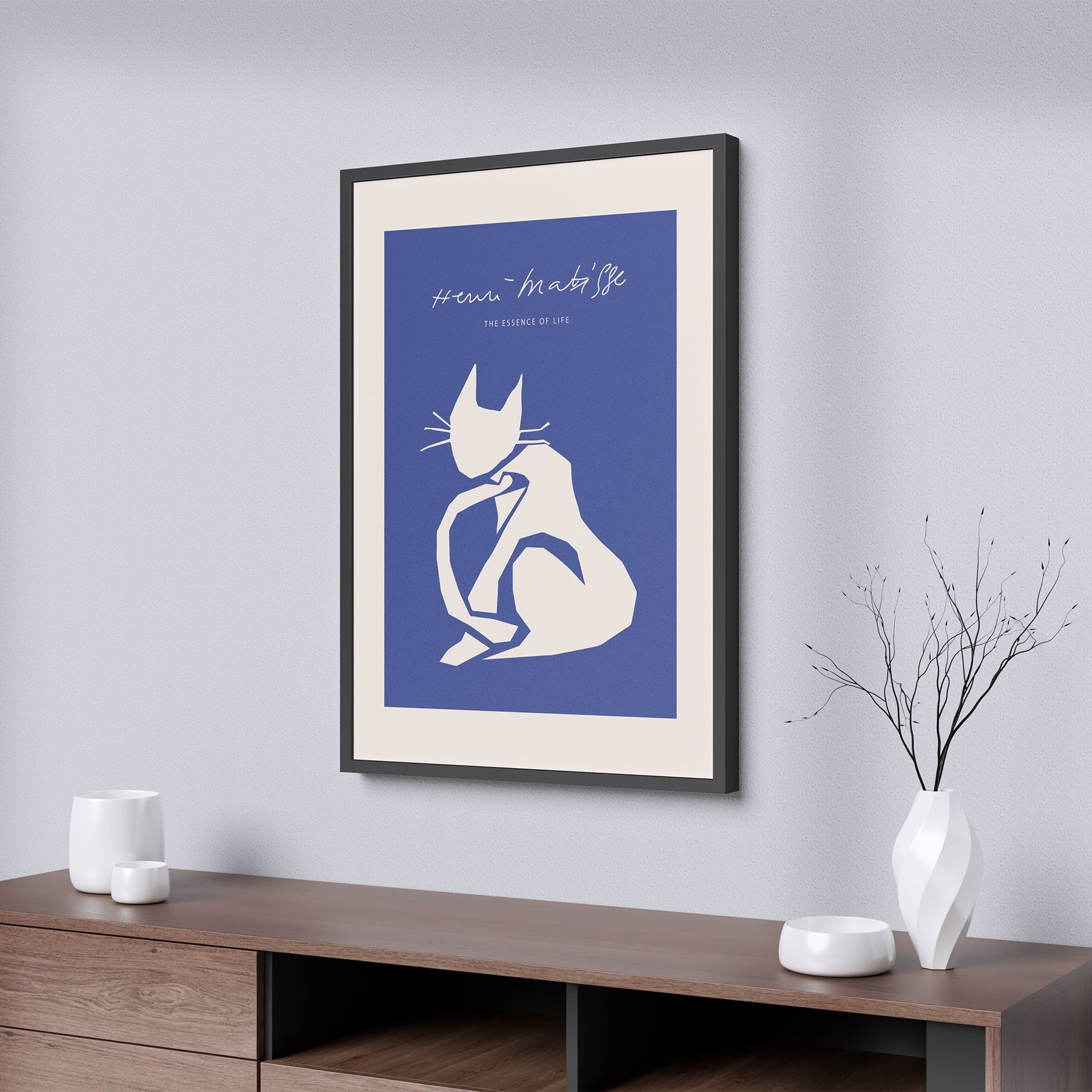 Framed poster of a cat silhouette on a blue background in a modern interior setting.