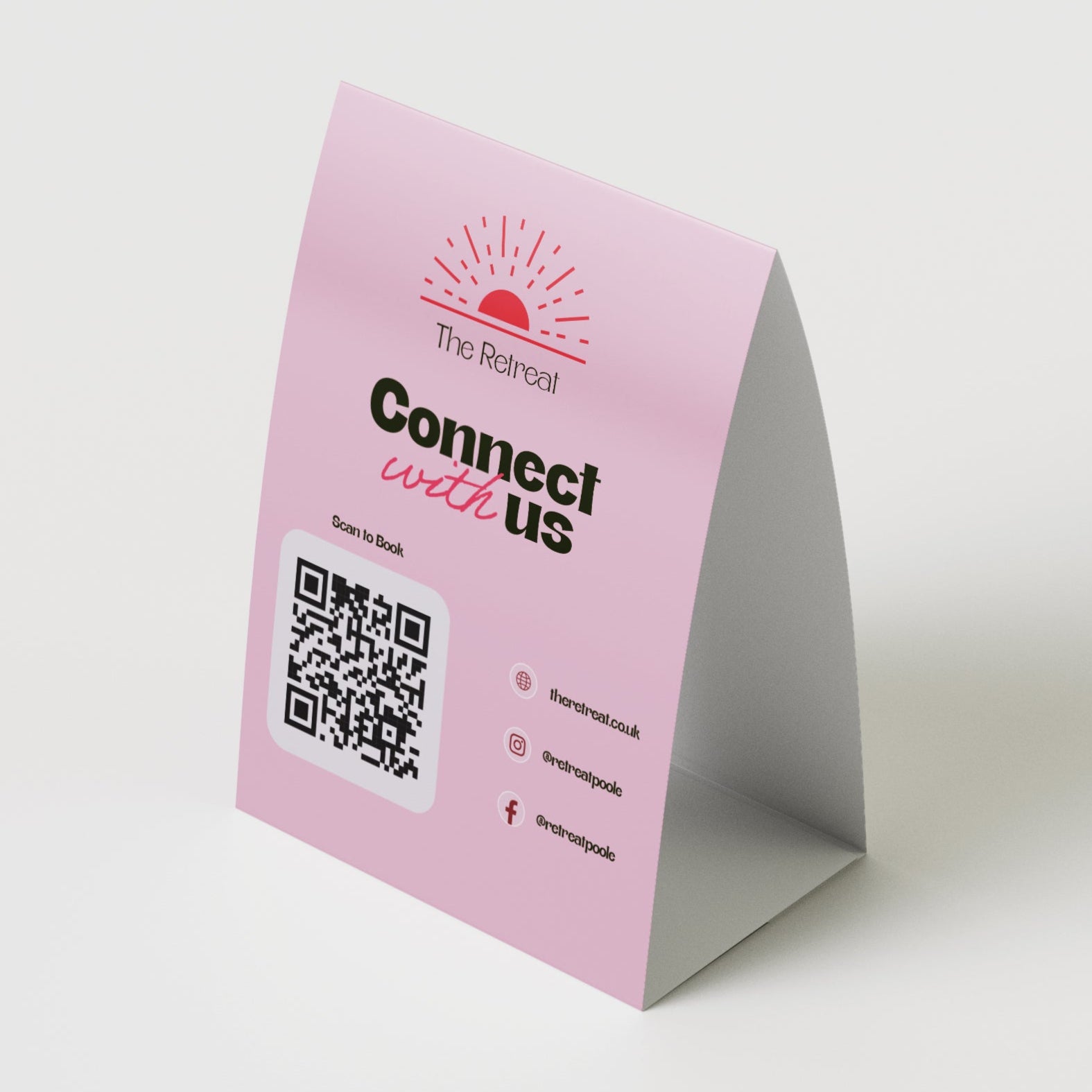 Pink table tent with QR code and text on a white background